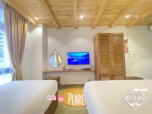 TV a/nebo společenská místnost v ubytování Riverside Mini Hotel Grand World Phu Quoc