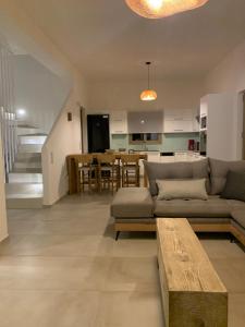 a living room with a couch and a kitchen at Villa Olia in Pitsidia