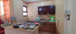 a kitchen with a counter with pots and pans at Al Haweej in Marsa Matruh
