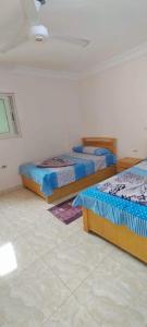a bedroom with three beds in a room at Al Haweej in Marsa Matruh