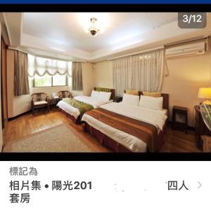 a hotel room with two beds and a window at Yun Siang Ju Homestay in Jiaoxi