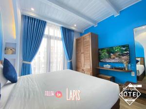 Postel nebo postele na pokoji v ubytování Riverside Mini Hotel Grand World Phu Quoc