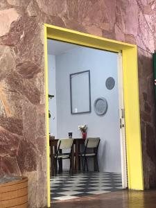 a room with a table and chairs and a door at Rock! and Hostel in Belo Horizonte
