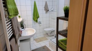 a white bathroom with a sink and a toilet at Wohlfühl-Ferienwohnung mit Tiefgarage im Grünen in Oberhof +31 photos