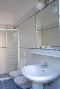 a bathroom with a sink and a toilet and a mirror at Da Irene in Mestre
