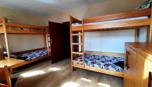 a room with three bunk beds and a desk at APARTAMENTY TR 11 Apartament nr 6 in Olsztyn