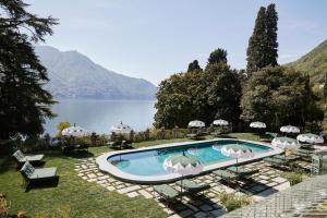 a swimming pool with a view of a lake at Passalacqua in Moltrasio