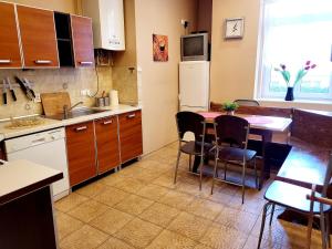 a kitchen with a table and a dining room at Tanie spanie przy Targach Poznańskich - zameldowanie bezobsługowe- in Poznań