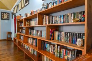 a row of wooden bookshelves filled with books at Traum House in Saint Augustine