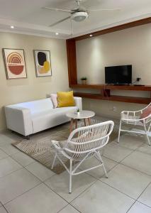 a living room with a couch and a table and chairs at Montana Eco Resort Aruba in Oranjestad