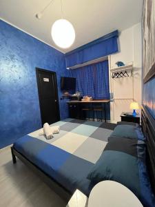 a blue bedroom with a bed and a desk at Light Home in Avellino