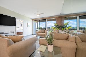 a large living room with couches and a tv at Wailea Grand Champions in Wailea