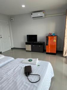 a room with two beds and a tv in it at Thana Apartment in Ban Phan Sadet Nai +75 photos