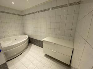 a bathroom with a tub and a toilet and a sink at Panorama in Tromsø +8 photos