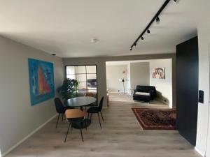 a living room with a table and chairs at Panorama in Tromsø