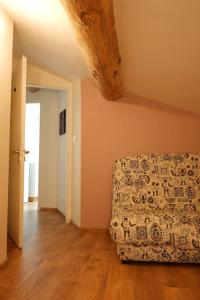 a living room with a couch and wooden floors at La Grange 1832 - A 10 mins d'Aubenas in Saint-Étienne-de-Boulogne