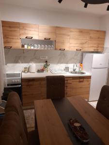 a kitchen with a table and a kitchen with a sink at Holiday apartaments 2 in Niš