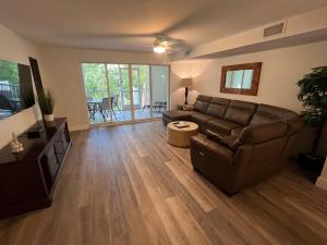 a living room with a couch and a television at LICENSED MGR - 3/3.5 MODERN VILLA - KEY LARGO'S PREMIER OCEANFRONT RESORT AND MARINA! in Key Largo