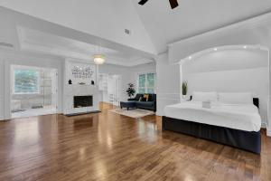 a white bedroom with a large bed and a fireplace at Buckheaddream Atlanta6bdrms Wbath In Every Room in Atlanta