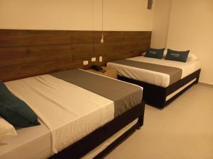 Postel nebo postele na pokoji v ubytování Hotel Colombia Avenida