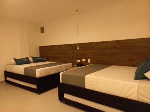 Postel nebo postele na pokoji v ubytování Hotel Colombia Avenida