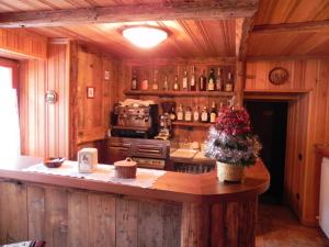 a kitchen with wooden walls and a counter with a stove at Le Vieux Rascard Chambres d'Hotes in Champoluc