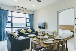 a living room with a table and a couch at Full Seaview 2R1B Condo for 6pax in Kota Kinabalu in Kota Kinabalu