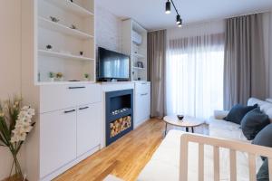 a living room with a couch and a tv at President Apartman 7 in Vračar (historical)