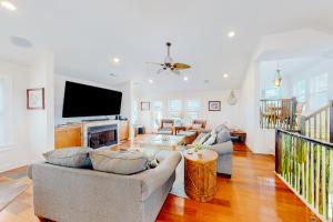 a living room with two couches and a flat screen tv at San Flamingo 486 in Rodanthe