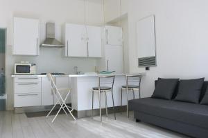 a kitchen and living room with a couch and a table at Design Canal Apartment in Corsico
