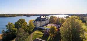 an aerial view of a large house on a lake at Rimforsa Strand in Rimforsa