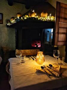 un tavolo con bicchieri da vino e una lampada sopra di Masia Can Felip B&B a Llinars del Vallès