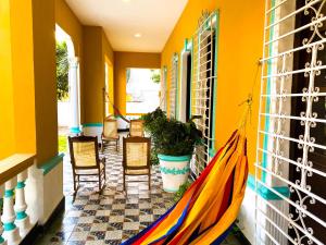 a porch with a hammock on the side of a house at Mansion Bahia Manga in Cartagena de Indias