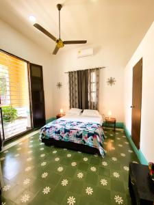 a bedroom with a bed and a green floor at Mansion Bahia Manga in Cartagena de Indias