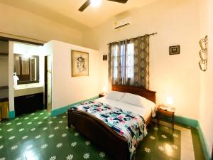 a hotel room with a bed and a bathroom at Mansion Bahia Manga in Cartagena de Indias