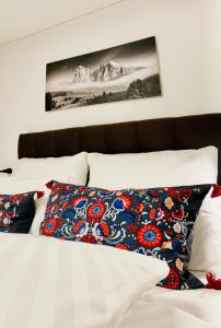 a bed with two pillows on top of it at Haus Kulala in Kaprun