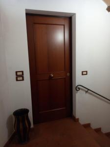 a wooden door in a room with stairs at La Casina di Veggio in Perugia