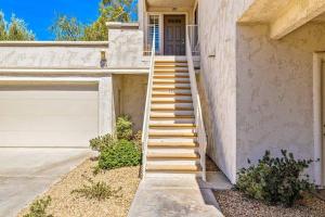 una escalera que conduce a una casa con garaje en Desert Falls Resort Villa w/ Golf & Mountain views!, en Palm Desert
