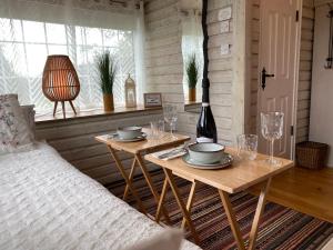 a room with two tables and a bed and a window at Adorable Cabin in the Countryside in Portlaoise
