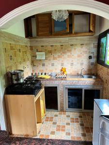 a kitchen with a stove and a counter top at Prestige beach résidence in Kribi