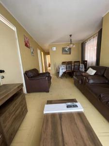 a living room with a couch and a table at Casa la serena condominio D. Gabriela in La Serena
