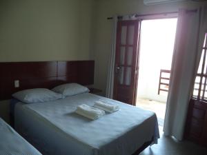 Кровать или кровати в номере Pousada Na Beira do Mar