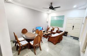a dining room with a table and chairs at BK House Melaka in Malacca