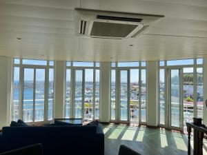 a living room with a view of the ocean at Vinha da Areia Beach Hotel in Vila Franca do Campo