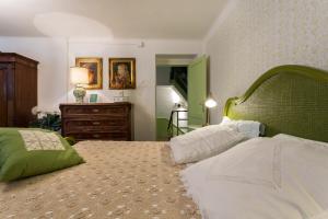 Posteľ alebo postele v izbe v ubytovaní Le Giuggiole 5 posti letto in una casa ricca d'atmosfera