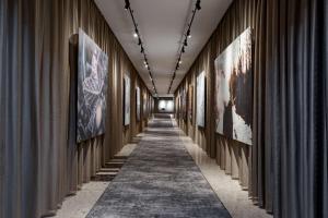 a hallway with paintings on the walls at Radisson Blu Latvija Conference & Spa Hotel, Riga in Rīga