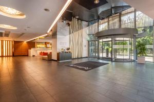 an empty lobby with a large room with a large window at Radisson Blu Elizabete Hotel, Riga in Riga
