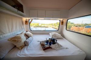 a room with a bed with a table on it at Caravana- Glamping Casa tortuga in La Nucía