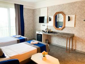 a hotel room with two beds and a mirror at NENESSAHOTEL in Aksaray