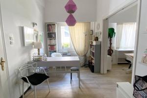 a room with a desk and chairs in it at 150m² Live/Work Unique&Sunlit Space in Athens in Athens